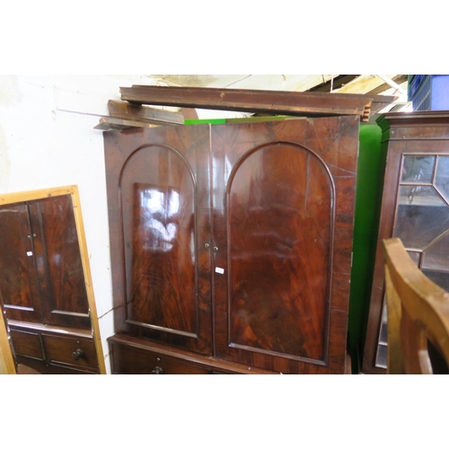 932 - A C19th mahogany press cupboard, the upper section fitted with slides over a lower section of two ov... 