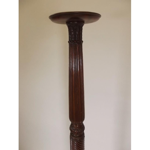 901 - A late Victorian mahogany torchère with carved decoration, raised on tripod supports, 64