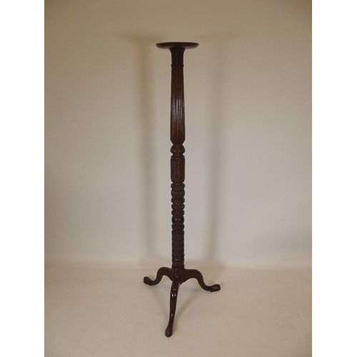 901 - A late Victorian mahogany torchère with carved decoration, raised on tripod supports, 64