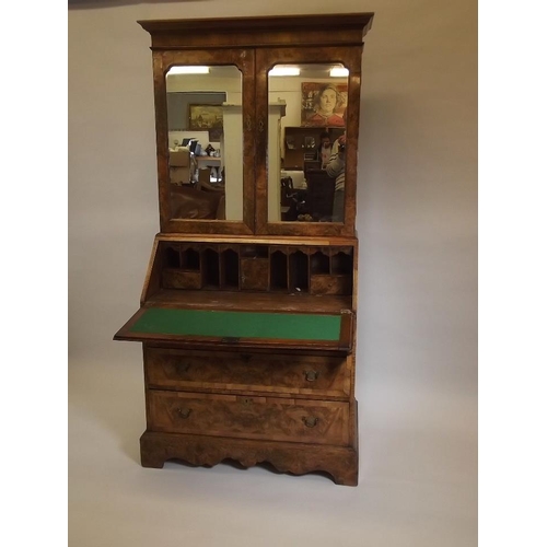 864 - A good quality Georgian style figured walnut bureau bookcase, the upper section with shelves behind ... 