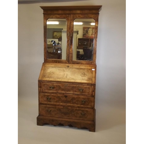 864 - A good quality Georgian style figured walnut bureau bookcase, the upper section with shelves behind ... 