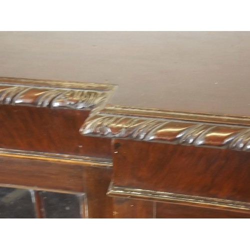 880 - A mahogany Chippendale style breakfront bookcase with four astragal glazed doors and gadrooned top, ... 