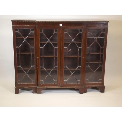 880 - A mahogany Chippendale style breakfront bookcase with four astragal glazed doors and gadrooned top, ... 