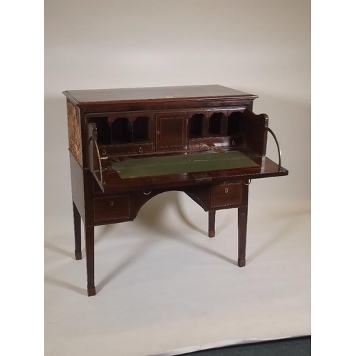 888 - A C19th inlaid mahogany kneehole secretaire, with fitted interior, raised on square tapering support... 