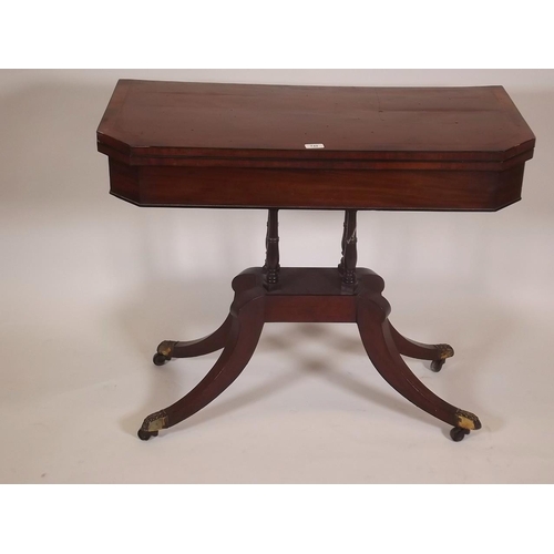 886 - An early C19th mahogany card table, with crossbanded top and canted corners, raised on four turned c... 