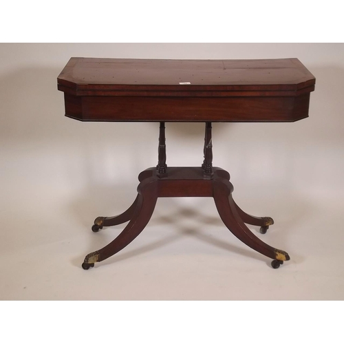 886 - An early C19th mahogany card table, with crossbanded top and canted corners, raised on four turned c... 