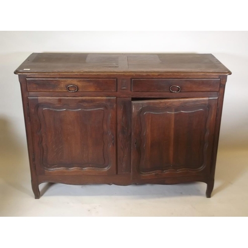 884 - A C19th French oak buffet a deux corps, the base section with two drawers over two cupboards, the up... 