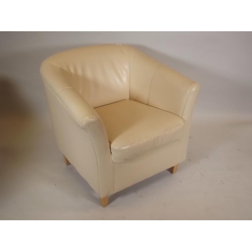 874 - A contemporary cream leatherette tub armchair