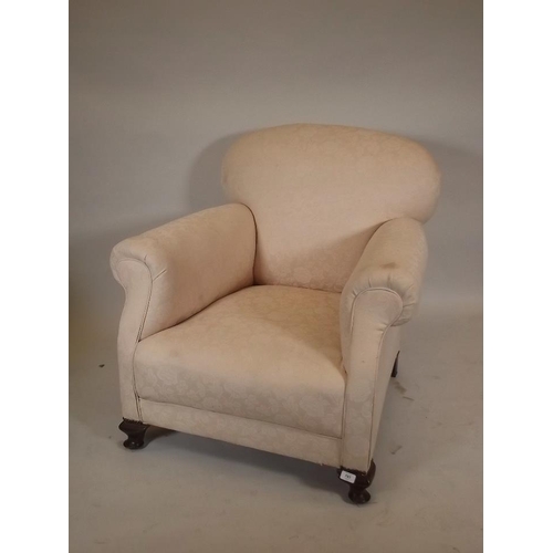 866 - A late C19th/early C20th easy chair, raised on small cabriole supports