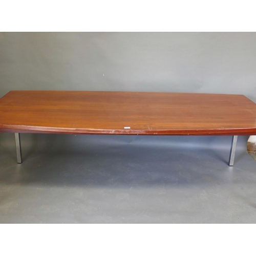 876 - A late C20th veneered and shaped top boardroom table of figured mahogany, raised on chromed supports... 