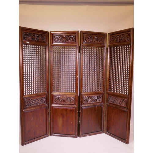 868 - An Oriental carved and pierced, stained fruitwood and pine four fold screen, each panel 17