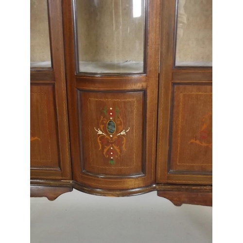 865 - An Edwardian inlaid mahogany display cabinet with two astragal glazed doors flanking a bow front cen... 