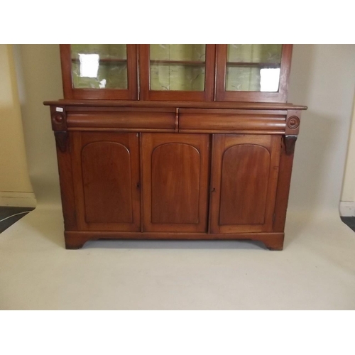 875 - A Victorian mahogany bookcase, the upper section with glazed doors over a base of two moulded frieze... 