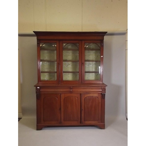 875 - A Victorian mahogany bookcase, the upper section with glazed doors over a base of two moulded frieze... 