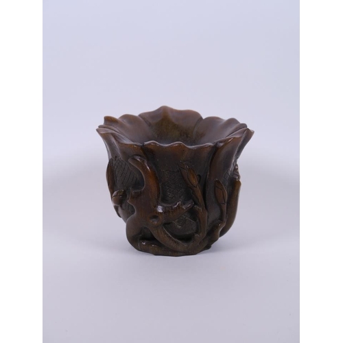 10 - A Chinese faux horn libation cup carved in the form of a lotus flower, seal mark to base, 4