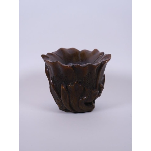 10 - A Chinese faux horn libation cup carved in the form of a lotus flower, seal mark to base, 4