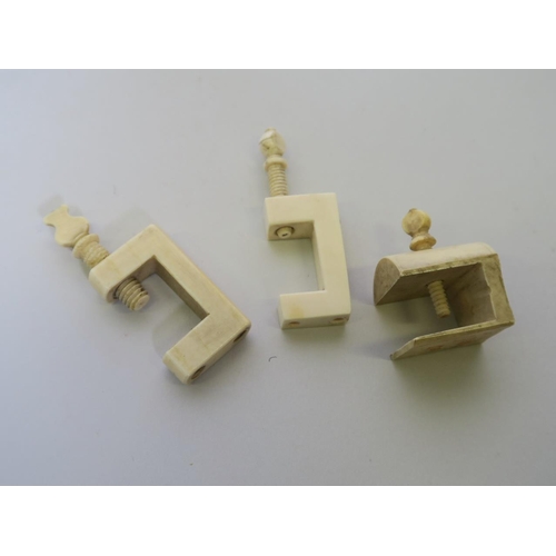 102 - Three C19th ivory sewing clamps, 3