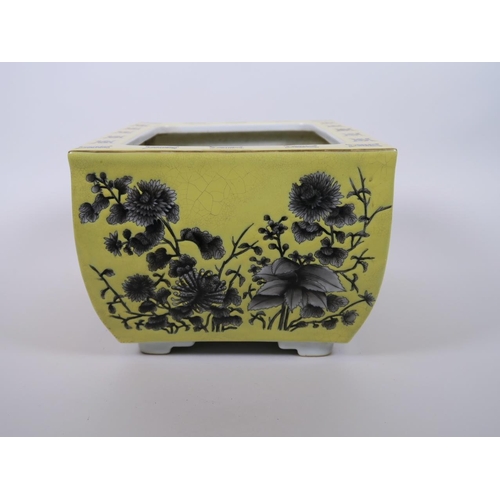 103 - A Chinese yellow ground porcelain planter with black and white floral decoration, character marks to... 