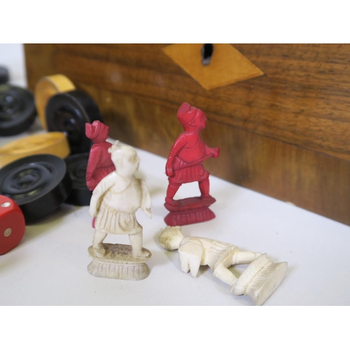 104 - A quantity of late C19th carved and stained ivory chess pieces, A/F and wooden draughts counters