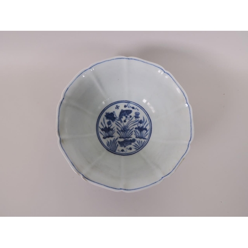 105 - A Chinese blue and white porcelain bowl of lobed form, decorated with carp in a lotus pond, 8