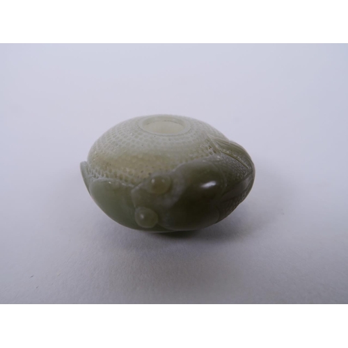 21 - A Chinese finely carved celadon jade pendant with goldfish decoration, 1½