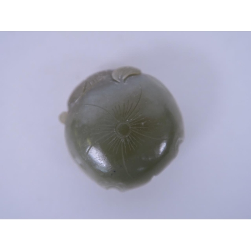 21 - A Chinese finely carved celadon jade pendant with goldfish decoration, 1½