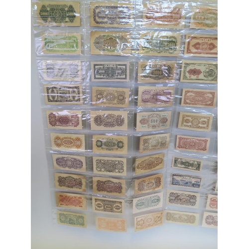 31 - A large quantity of Chinese facsimile (replica) bank notes, in two wall hanging wallets, largest not... 