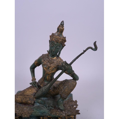 37 - A Thai bronze figure of a musician in traditional garb with green and gilt patina, 8