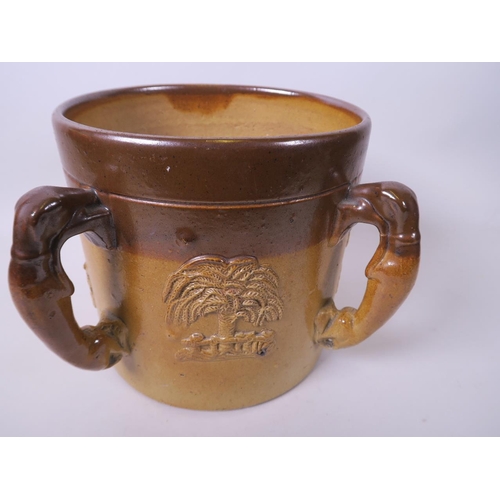 42 - A large C19th salt glazed stoneware tankard with four greyhound handles and embossed figure and tree... 