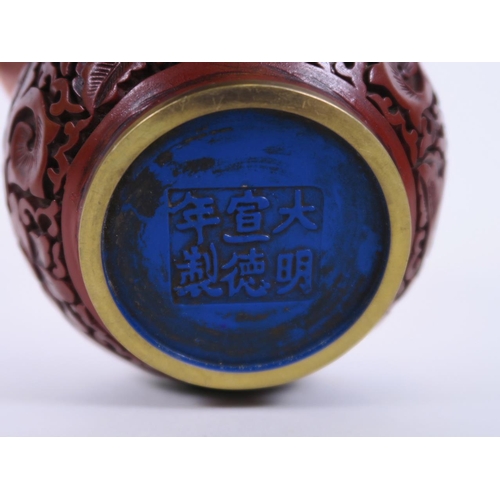 55 - A Chinese cinnabar lacquer pot and cover with lotus flower decoration, six character mark to base, 4... 