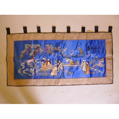 64 - A large Chinese silk embroidered wallhanging, depicting the eight immortals in a garden, 51½