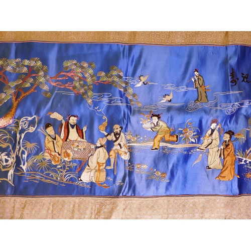 64 - A large Chinese silk embroidered wallhanging, depicting the eight immortals in a garden, 51½