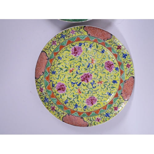 72 - A Chinese porcelain plate decorated with butterflies on a green ground and central medallion, 9½