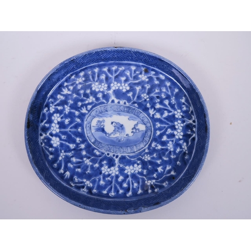 82 - An Oriental blue and white oval platter decorated with hawthorn blossom and a central panel of a fig... 