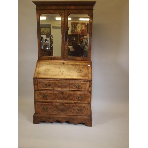 864 - A good quality Georgian style figured walnut bureau bookcase, the upper section with shelves behind ... 