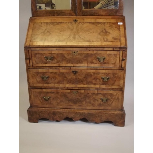 864 - A good quality Georgian style figured walnut bureau bookcase, the upper section with shelves behind ... 