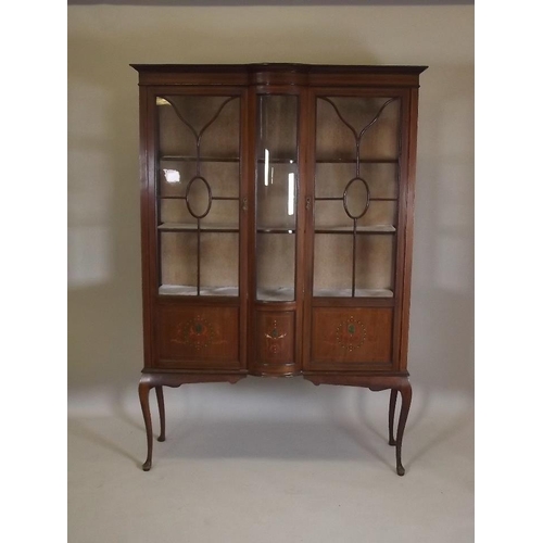 865 - An Edwardian inlaid mahogany display cabinet with two astragal glazed doors flanking a bow front cen... 