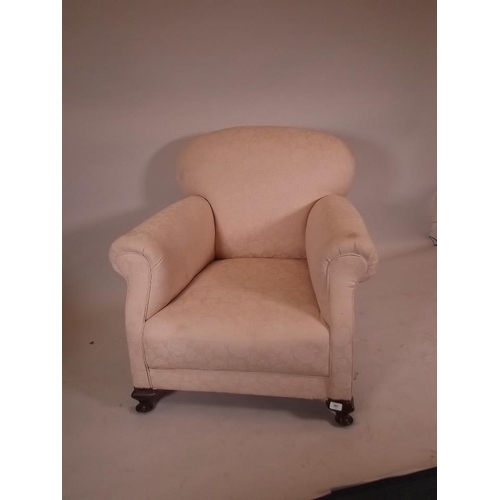 866 - A late C19th/early C20th easy chair, raised on small cabriole supports