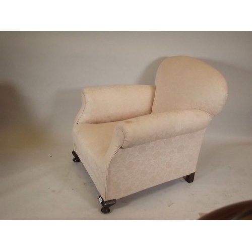 866 - A late C19th/early C20th easy chair, raised on small cabriole supports