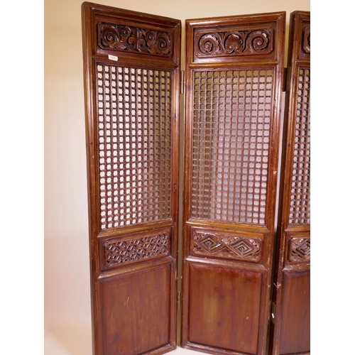 868 - An Oriental carved and pierced, stained fruitwood and pine four fold screen, each panel 17