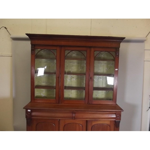 875 - A Victorian mahogany bookcase, the upper section with glazed doors over a base of two moulded frieze... 