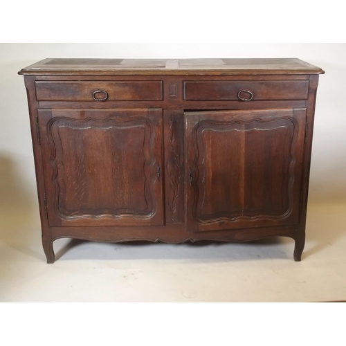 884 - A C19th French oak buffet a deux corps, the base section with two drawers over two cupboards, the up... 