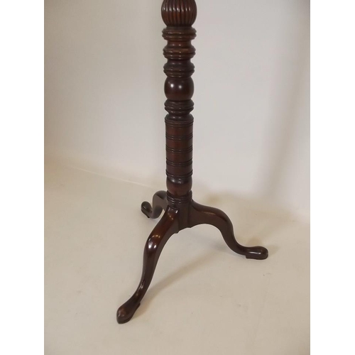 901 - A late Victorian mahogany torchère with carved decoration, raised on tripod supports, 64