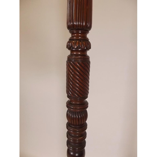 901 - A late Victorian mahogany torchère with carved decoration, raised on tripod supports, 64