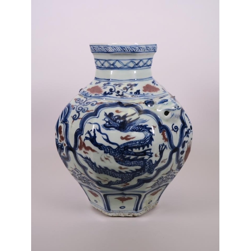 93 - A Chinese octagonal blue and white pottery jar with mask handles and decorative panels with red high... 