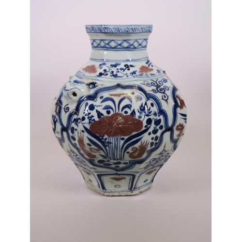 93 - A Chinese octagonal blue and white pottery jar with mask handles and decorative panels with red high... 