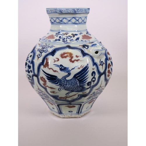 93 - A Chinese octagonal blue and white pottery jar with mask handles and decorative panels with red high... 