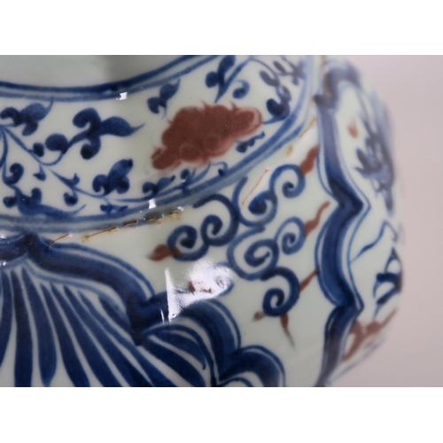 93 - A Chinese octagonal blue and white pottery jar with mask handles and decorative panels with red high... 