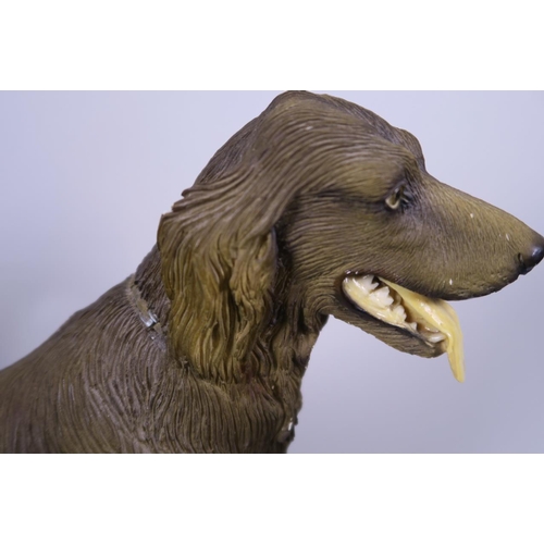 11 - A resin figurine of an Irish Setter dog, mounted on a wooden base, 10