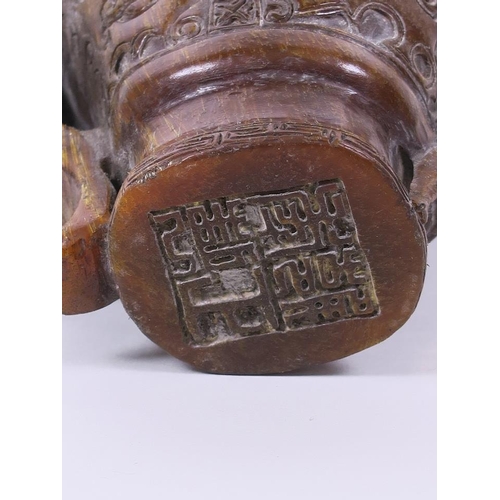 20 - A Chinese faux horn libation cup with carved dragon decoration, 4½